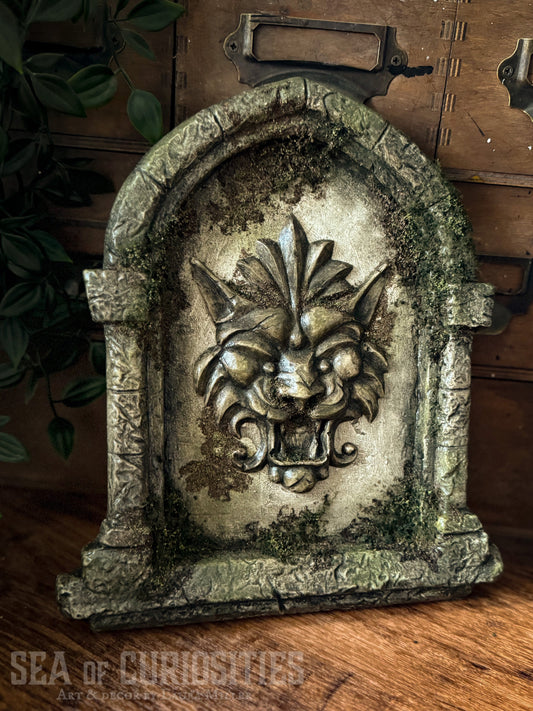 Decorative sculpted stone wall arched window with Lion head, branded 'Sea of Curiosities'.